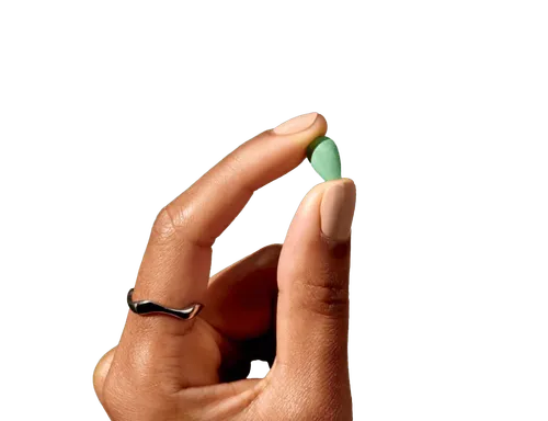 Hand holding a hair-care capsule